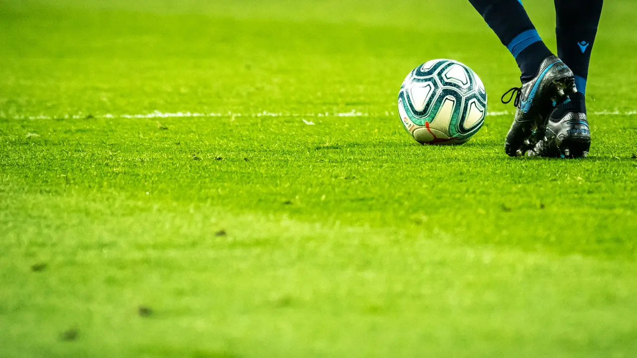 Jogadores em partida de futebol no campo